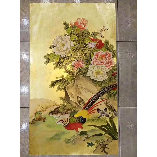 A luxurious hand painted gold leaf wallpaper featuring an elegant oriental composition of colorful phoenix birds, blooming...