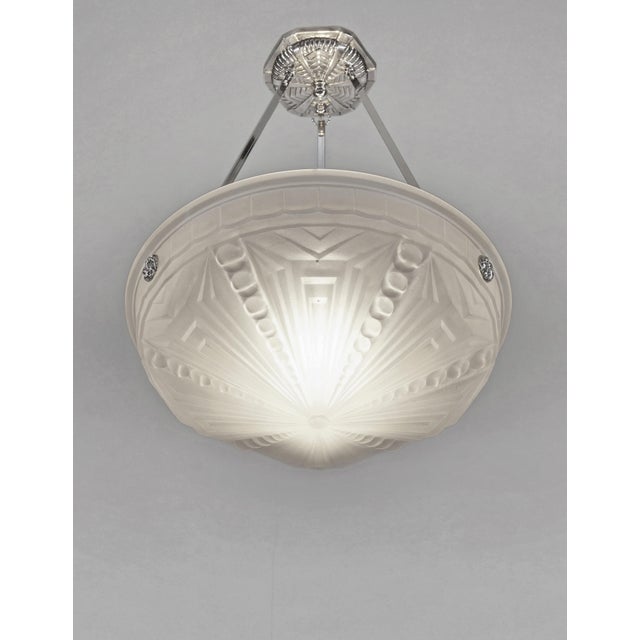MULLER FRERES A nice French 1925-1930 art deco chandelier in nickel plated solid brass or bronze holding a bowl by Muller...