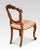 Set of four walnut balloon back dining chairs, each chair with an openwork ring back interlaced with carved scrolling...