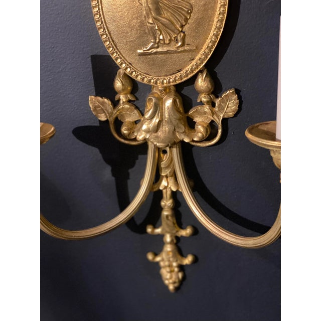A pair of circa 1920’s gilt bronze neoclassic style sconces