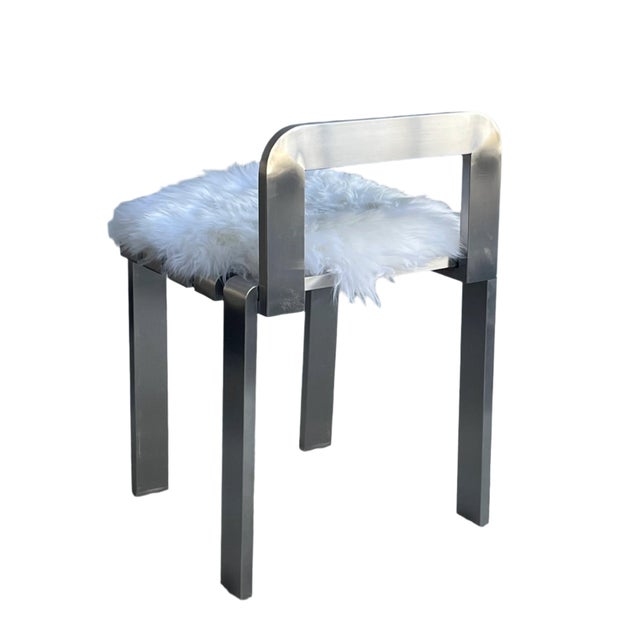 Add a touch of modern charm to any space with the Tara Silver Metal Chair with sheepskin pad. Made of stainless steel,...