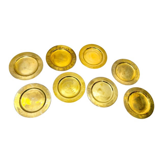 Vintage mid century set of 8 solid brass charger plates, made in India. The plates have a heavy, substantial weight to...