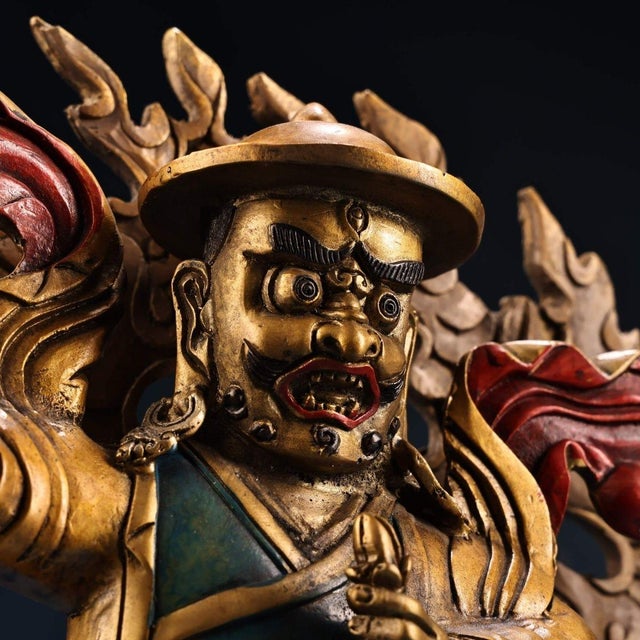 Powerful vintage bronze statue of Dorje Shugden, the revered Dharma protector of Tibetan Buddhism, seated atop a roaring...