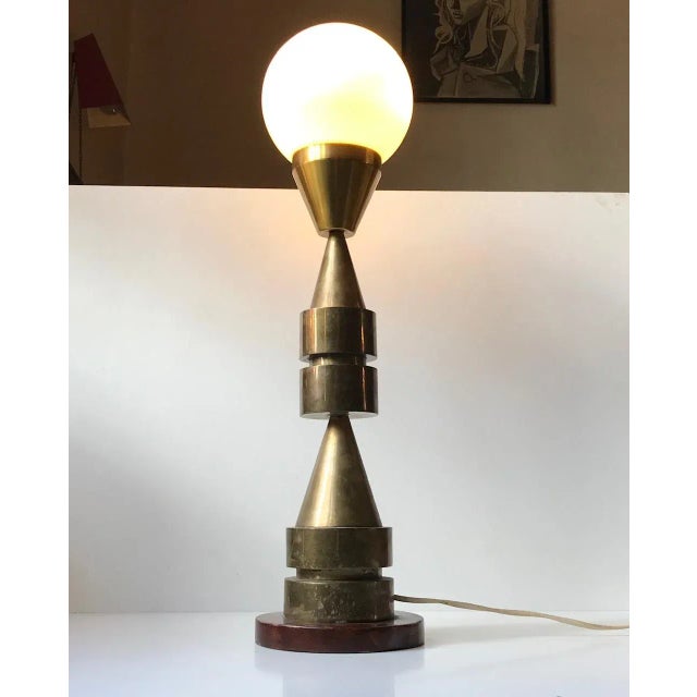 This totem-shaped table light is composed of a nautical measuring instrument. It has been attached to a wooden base and...