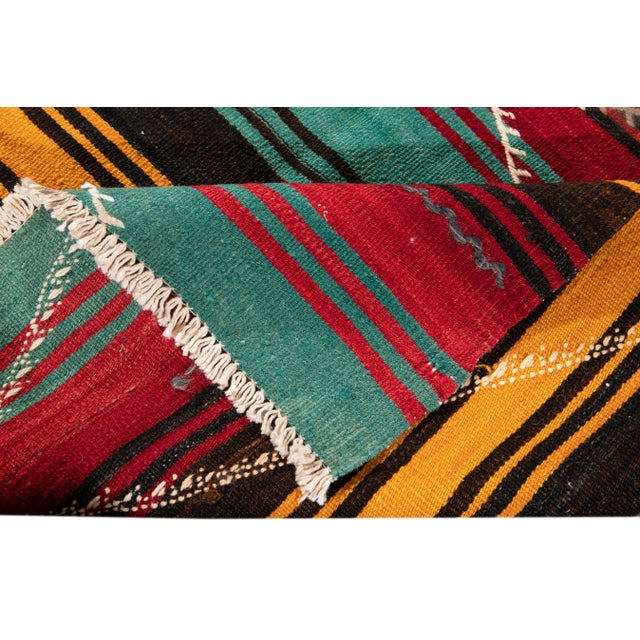 Beautiful vintage Persian Kilim hand-knotted wool runner with a multicolor field. This rug has a gorgeous geometric tribal...