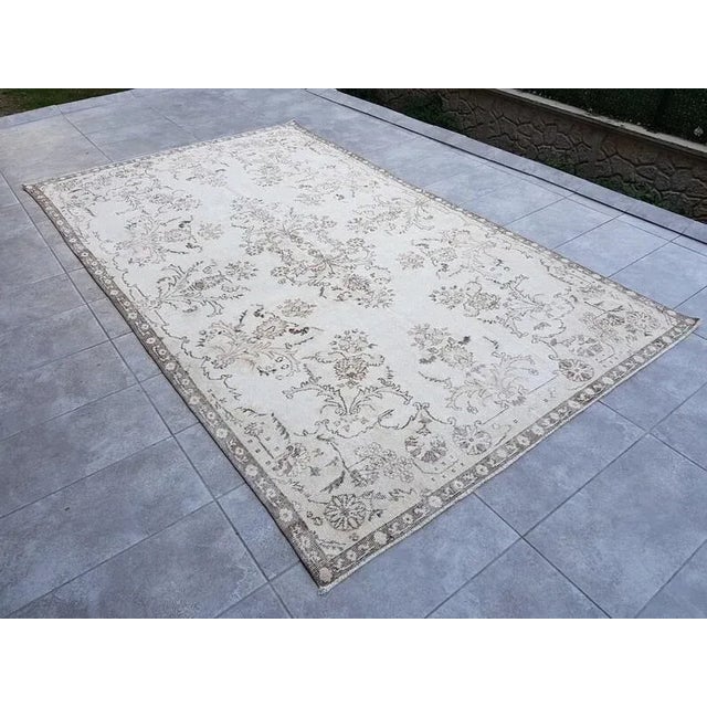 This is a vintage Turkish Oushak rug from the 1960s. The piece was hand-knotted