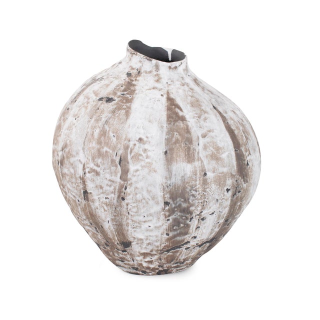 Reminiscent of weathered stone and desert landscapes, this artisan-crafted piece features a richly textured surface in...