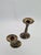 An elegant pair of candlesticks made of solid brass, with a classic, slender form, a flared base, and a delicately...