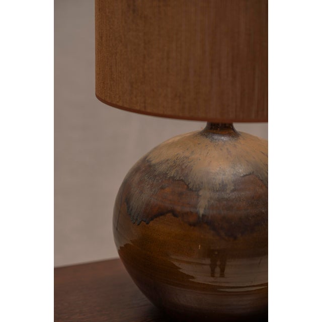 Impressive French table lamp from the 1970s, featuring a generously proportioned spherical ceramic base with a beautiful...