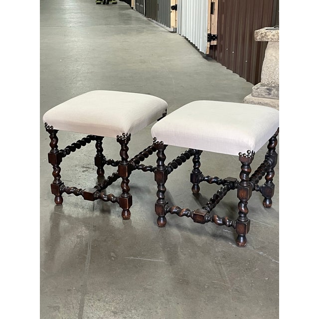 A Pair of Newly upholstered antique stools with English oak barley twist legs and stretchers.
