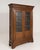 A French oak vitrine dating to the late 19th century. The cabinet features glass-front doors and a simple, well-balanced...