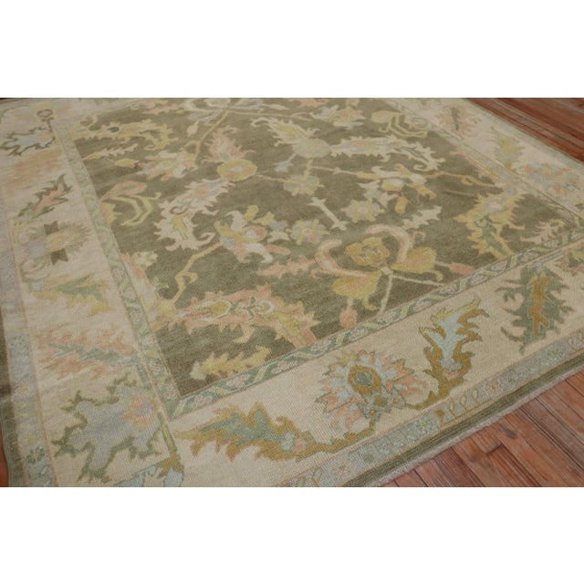 One of a kind, mid 20th-century Hand-knotted wool Turkish Room Size Rug with an all over design on a brown green color...