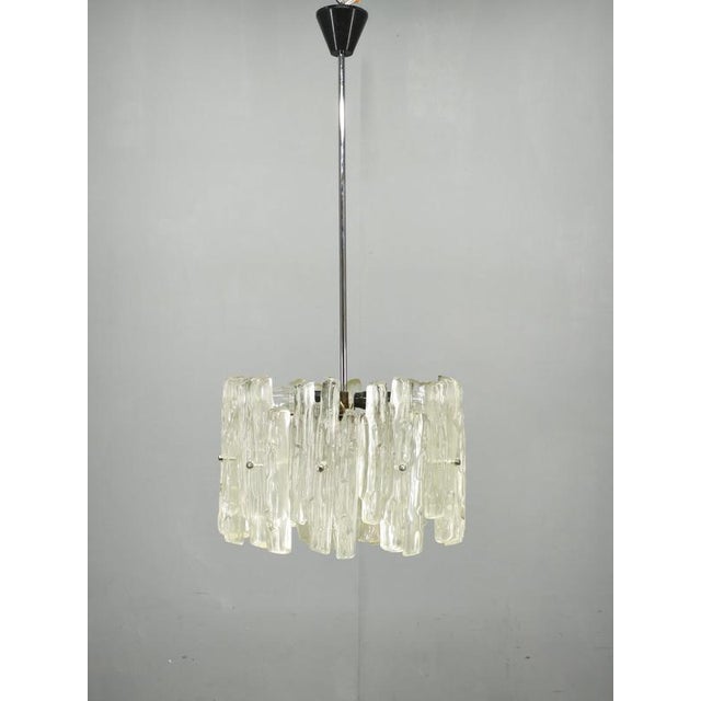Exceptional austrian pendant light from the 1960s, attributed to j.t. Kalmar. This highly decorative chandelier features...