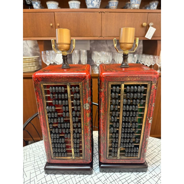 Exquisite pair of red and gold gilt wood chinoiserie table lamps. Made from an original suanpan/ abacus tool used for...