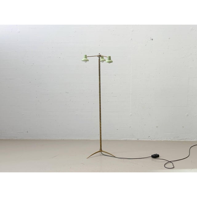 Elegant three-light vintage floor lamp with a finely crafted brass frame and a distinctive twisted central stem. The...