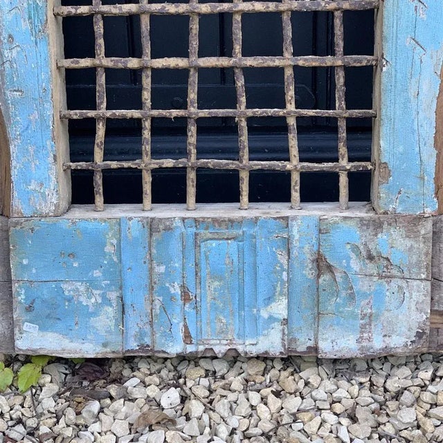 Wooden grid and wrought iron with a very beautiful blue patina. Extremely rare and very decorative element.