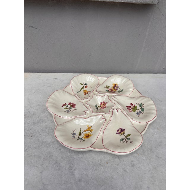 Majolica oyster plate with different flowers on each shells, circa 1900 signed Longchamp.