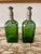 Lovely pair of vintage green decanters with pewter cages labeled in gothic style font. One labeled “Rye” and the other...