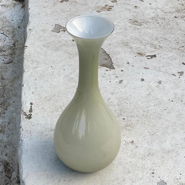This vase is made in glass in Oplaline. It has been made in Italy in the 1960s. It is a green color.