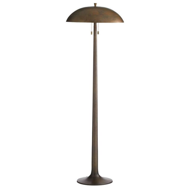 This floor lamp's trumpet base and gong shape update a Space Age silhouette. This reinvented form of vintage brass-plated...