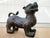 This bronze guardian lion or foo dog was crafted in the 20th Century and rendered with an intricate floral-patterned...