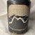 This beautiful studio art pottery cylinder vessel features highly detailed, stylized mountain landscape panels. The...