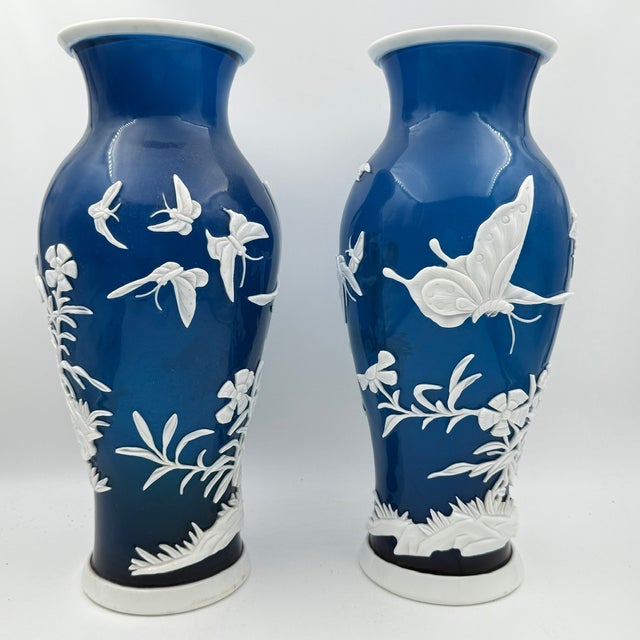 A pair of Chinese Peking (Beijing) glass vases, each of baluster form with a flared trumpet neck, cased in cobalt-blue...