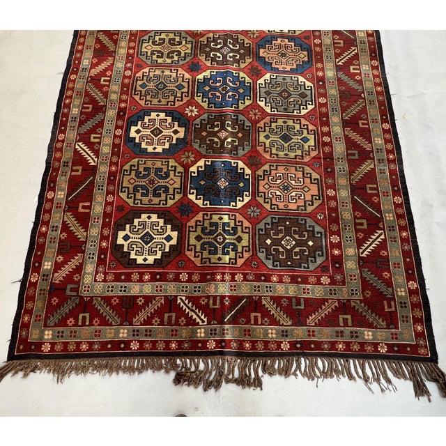 A vintage Caucasian Soumak — a collectible flatweave built by wrapping colored wefts rather than knotting — carrying three...