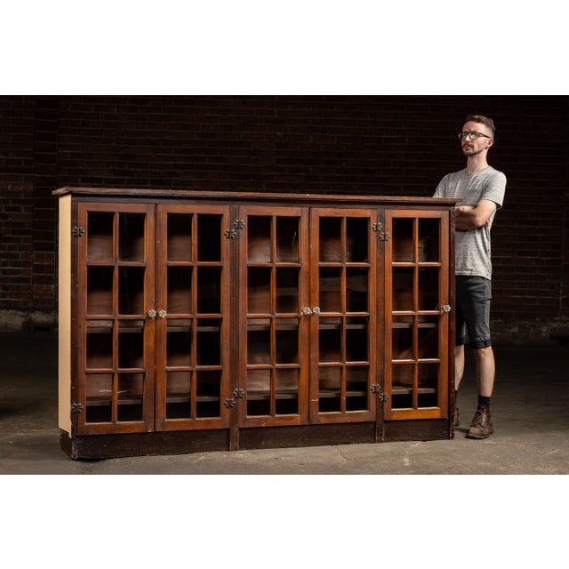 Low-profile oak cabinet fitted with six glass-paneled doors and interior shelving. Crafted in solid oak with a deep, warm...