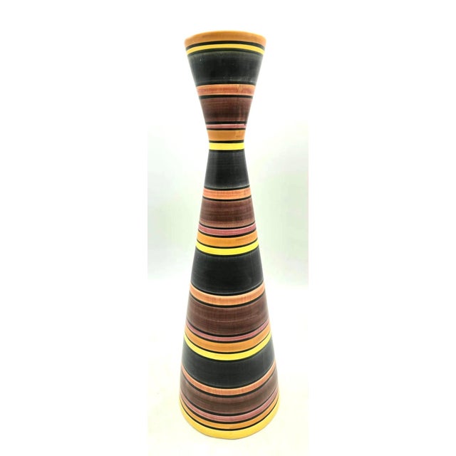 Offered is a vintage mid-century modern ceramic hourglass or "diabolo" style vase featuring horizontal multi-colored...