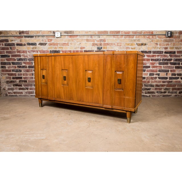 Lovely mid-century long dresser/credenza from John Widdicomb. It has gorgeous woodgrain, lovely brass hardware and brass...