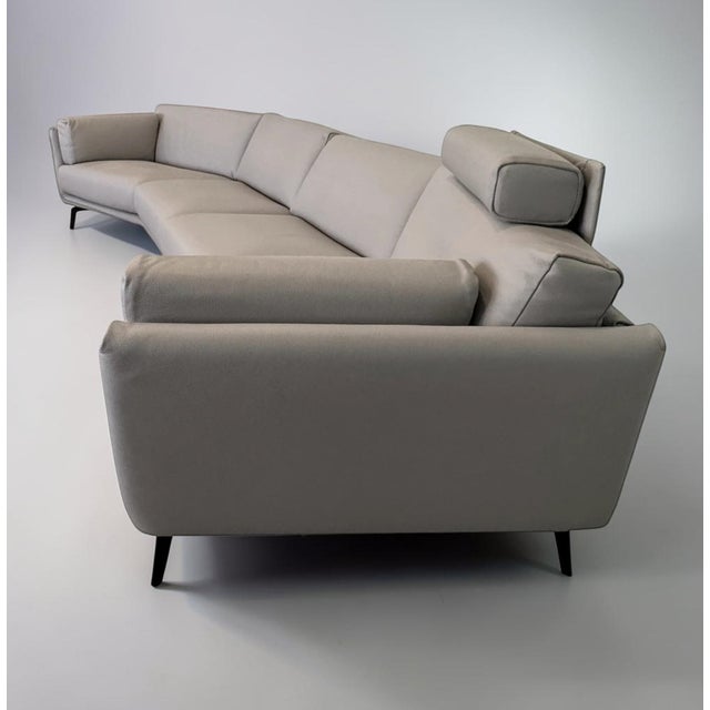 This angled sofa pairs functionality and style seamlessly together to create a luxurious seating solution for a modern...