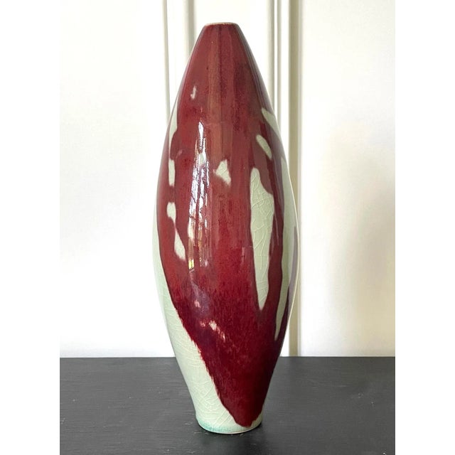 A spindle form porcelain vase by Brother Thomas Bezanson (1929-2007). As a modern interpretation of "Mei-Ping", a classic...