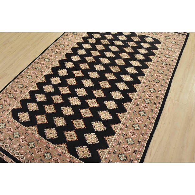 A tribal Bokhara Jaldar rug hand-knotted with fine wool on a cotton foundation. This rug features rows of repeating...