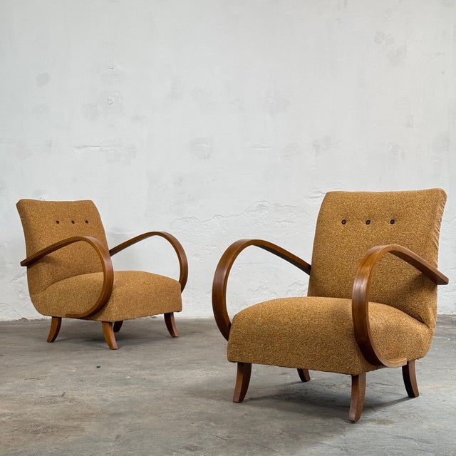This pair of h-410 armchairs represents a pinnacle of art deco design, created in the 1930s by the celebrated czech...