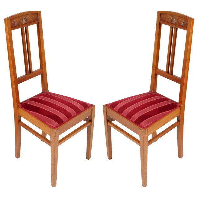 Elegant italian art nouveau side chairs with stool, in blond walnut, hand carved, wax polished. Precious two-colored...