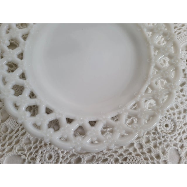 A lovely small milk glass plate, with a delicate lace-like edge. This would look great hung on the wall with other milk...