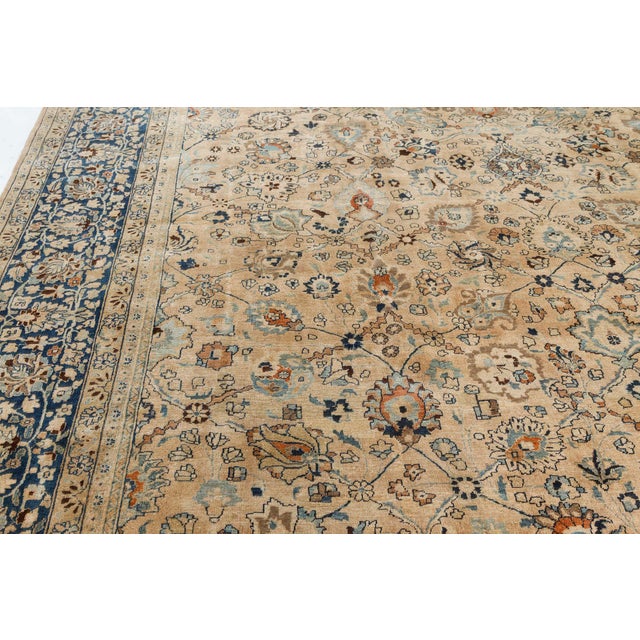 A late 19th century Khorassan rug from Persia, the caramel field with an allover trellis of palmettes and vinery with...