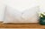 This handcrafted Moroccan cactus silk lumbar pillow reads first as texture, then as pattern — a soft tonal ivory ground...