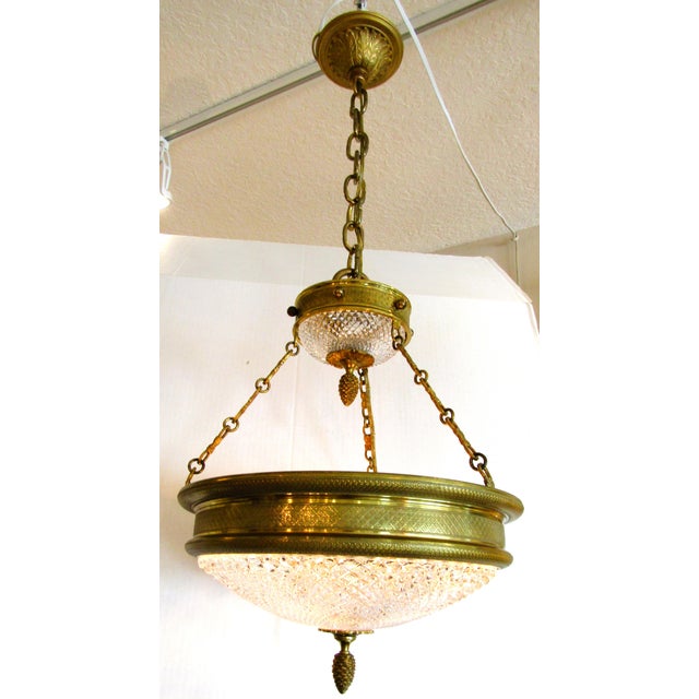 The Vintage Sherle Wagner Empire Style Bronze and Cut Crystal Chandelier is a stunning piece of lighting that exudes...