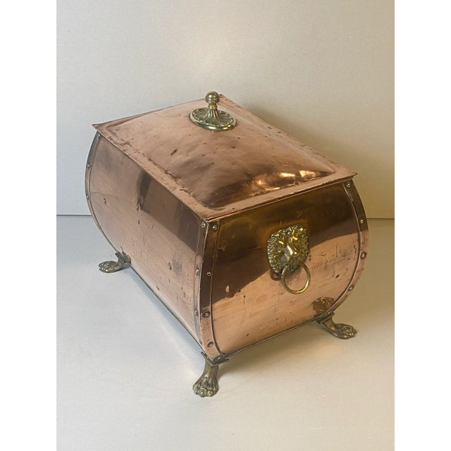 Elegant early 19th century English copper and brass coal hod. Brass lion’s head handles and paw feet. Beautiful brass...