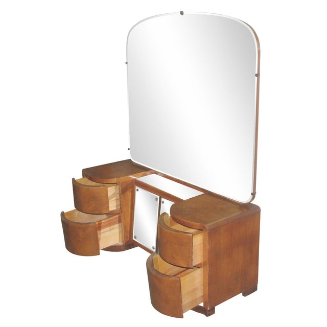 Art Deco wooden vanity with two curved drawers at either end and a double door mirrored cabinet between. The piece...