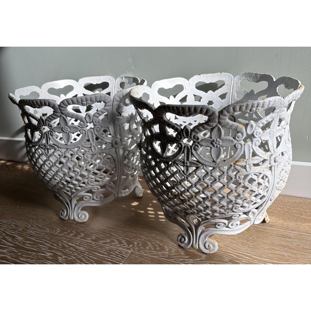A beautifully matched pair of French Garden / 3Victorian-style cast iron planters featuring intricate openwork, floral...