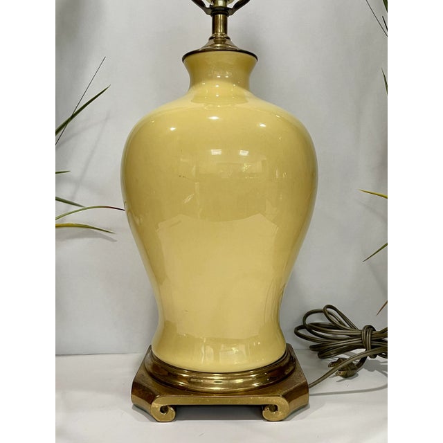 Here is a Fabulous mid century lemon yellow porcelain table lamp with brass accents. Well made and the color is just...