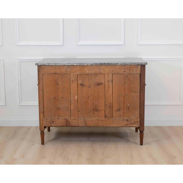 Dating to the eighteenth century and made in France, this Louis XVI chest of drawers is constructed in walnut and opens at...