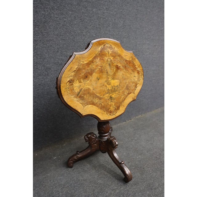 Victorian Black Forest style occasional table featuring a shaped walnut top with satinwood marquetry inlay. The top is...