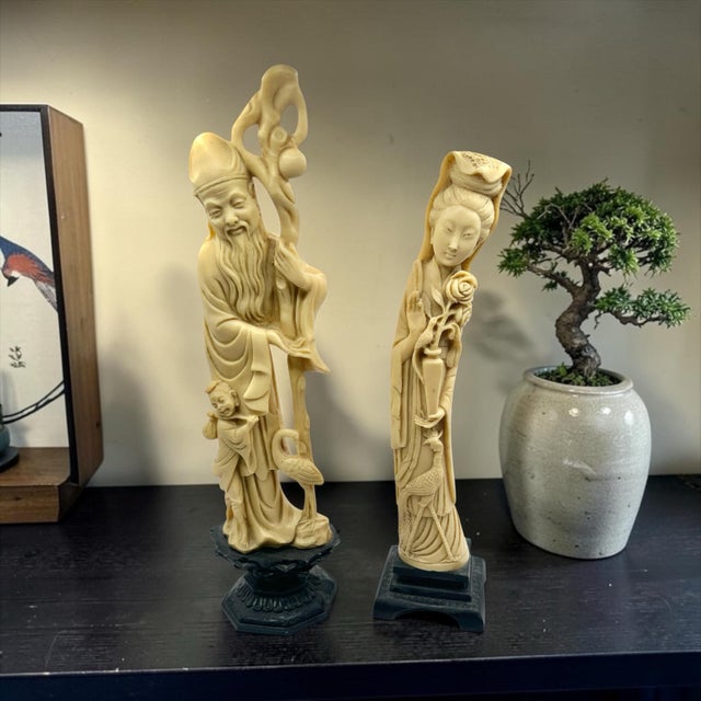 A Pair of carved bone or ivory-like resin figurines depicting Shou Xing (God of Longevity) and Guanyin (female immortal).