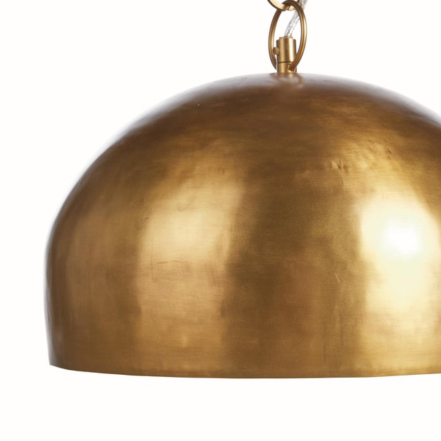 A modern statementworthy pendant with a lightly pounded textured metal dome shade. Finished in a warm champagne tone, this...