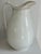 Tall, good form, ironstone pitcher. There is slight crazing and discoloration, in good useable condition.