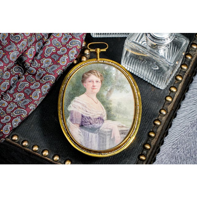 This remarkable oversized portrait miniature, dated 1912 and artist-signed, captures the refined elegance of the Gilded...